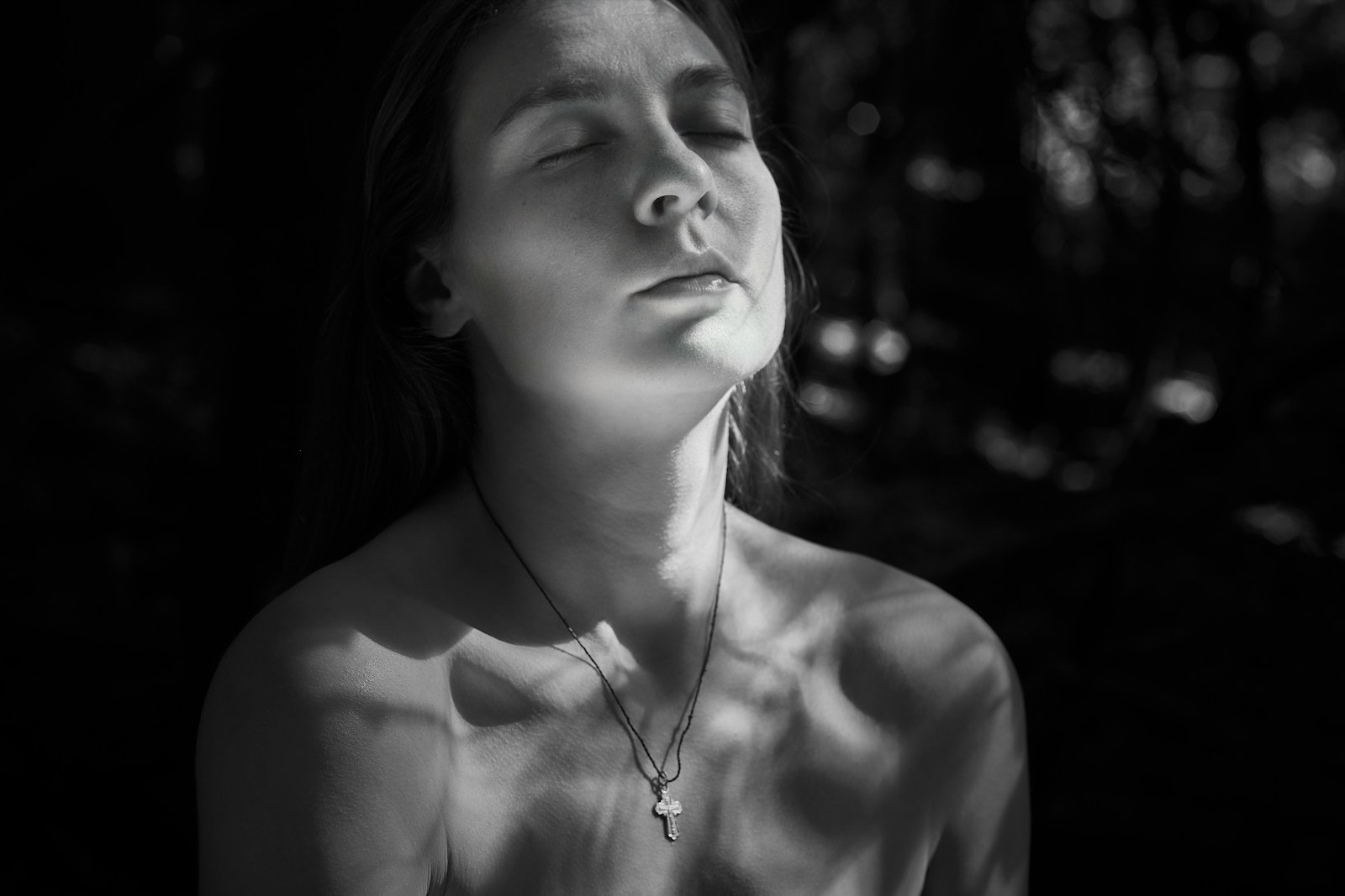 a black and white photo of a woman with her eyes closed